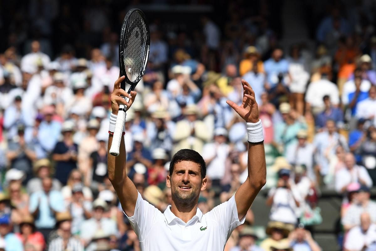 Serbia's Novak Djokovic celebrates beating Spain's Roberto Bautista Agut during their men's singles semi-final match on day 11 of the 2019 Wimbledon Championships at The All England Lawn Tennis Club in Wimbledon, southwest London. AFP photo