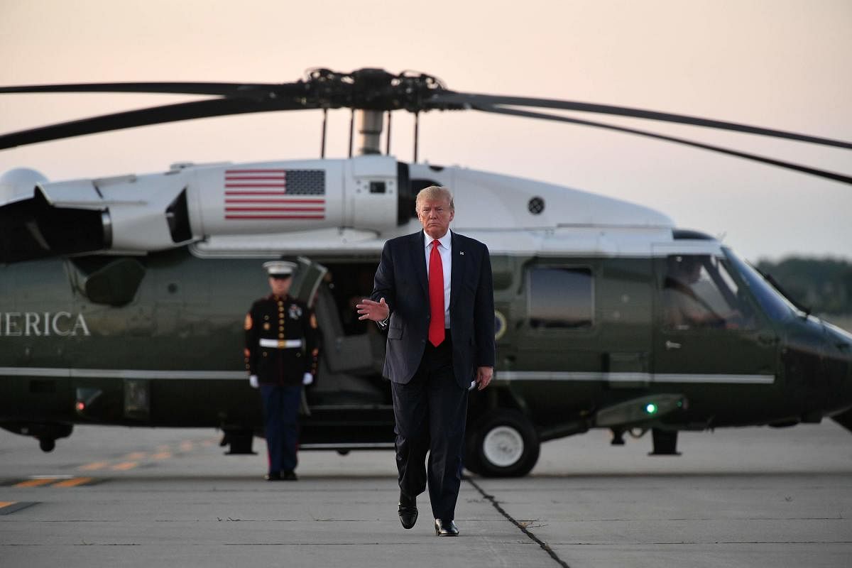 US President Donald Trump makes his way to board Air Force One before departing from Cleveland Hopkins International Airport in Cleveland, Ohio on July 12, 2019. (Photo by MANDEL NGAN / AFP)