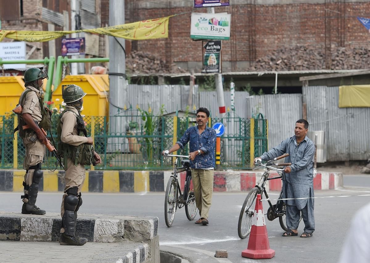 Security personnel stand guard during restrictions at Downtown in Srinagar. (PTI Photo)