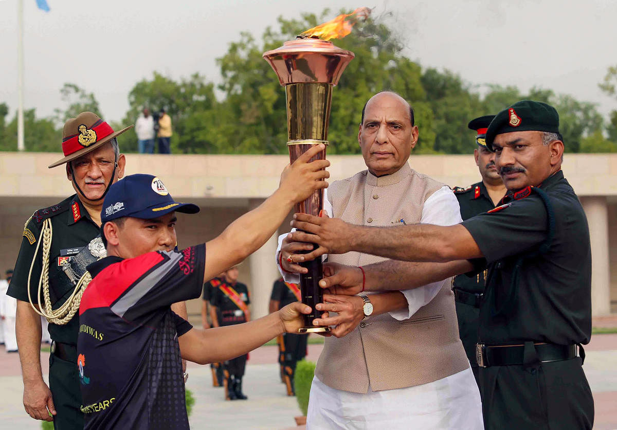 Defence Minister Rajnath Singh during the flag off ceremony of the ‘Victory Flame’ which will reach Drass on ‘Vijay Diwas’, at the National War Memorial in New Delhi. (PTI Photo)