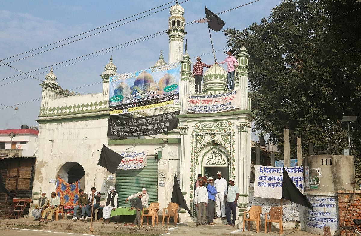 Muslims fix black flags at a mosque as they observe the Babri Masjid demolition anniversary as Black Day, in Ayodhya on Tuesday. PTI file photo