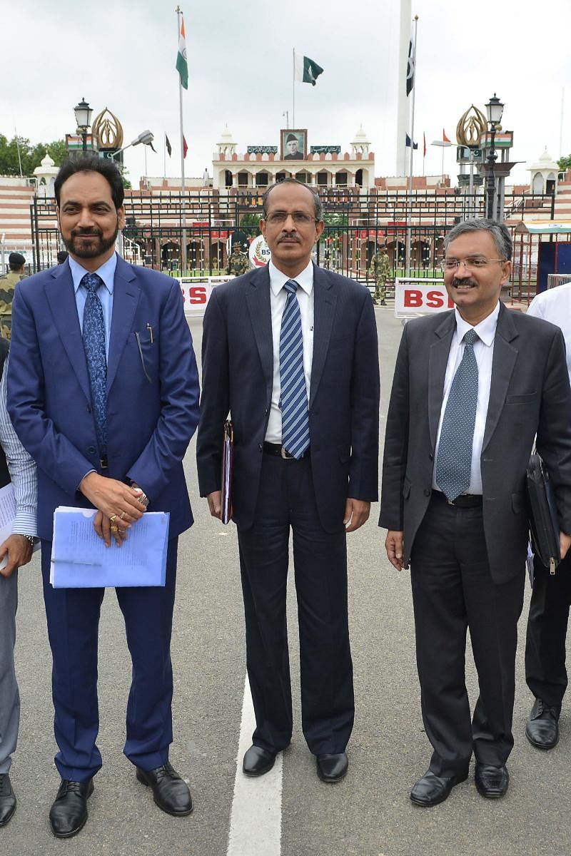 Joint Secretary of Indian Home Ministry SCL Das (C), Ministry of External Affairs joint Secretary Deepak Mittal (R) and Punjab Government PWD Secretary Hussan Lal (L) return to India after attending a meeting with their counterparts on the issue of Kartar