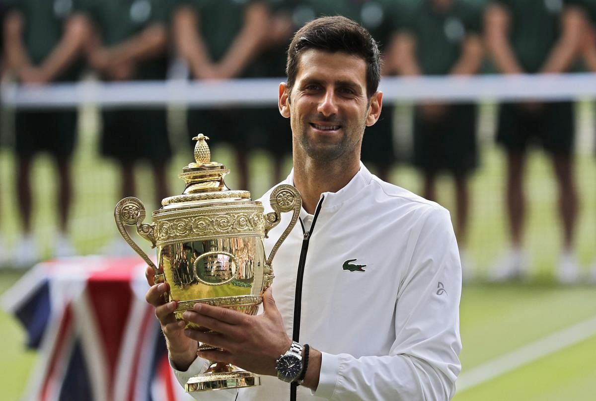 Serbia's Novak Djokovic poses with his trophy after defeating Switzerland's Roger Federer in the men's singles final match of the Wimbledon Tennis Championships in London (AP/PTI Photo)