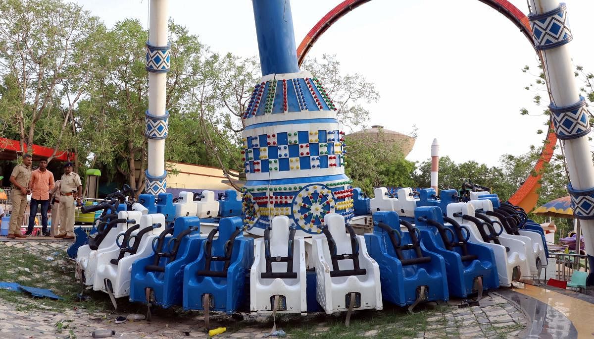 Policemen stand near a collapsed amusement ride in Ahmedabad, Sunday, July 14, 2019. (PTI Photo)