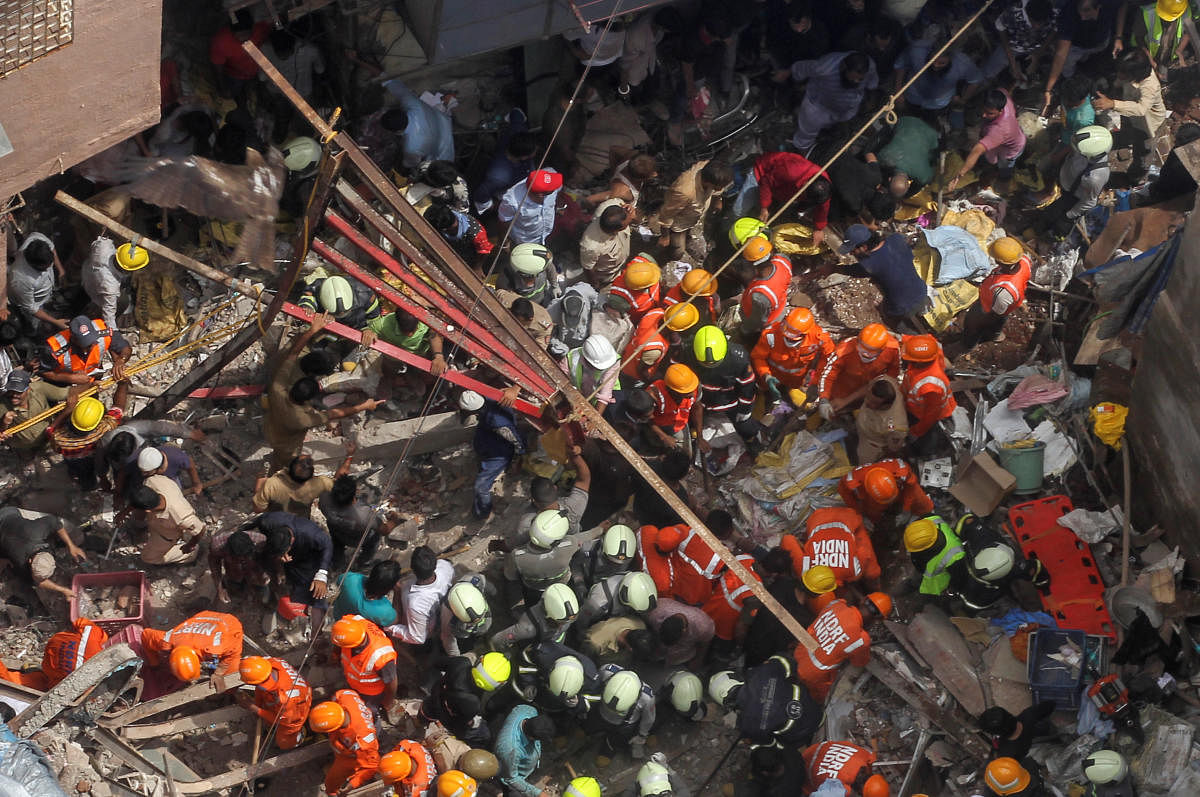 Rescue workers search for survivors at the site of a collapsed building in Mumbai.  Reuters photo