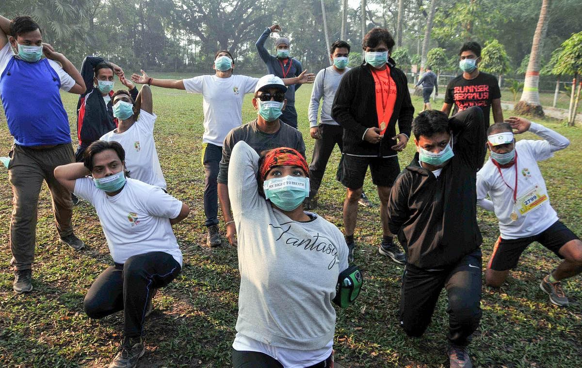 People perform physical exercises during an awareness campaign for 'Right to Breath' against air pollution, in Kolkata on Dec. 9, 2018. (PTI Photo)