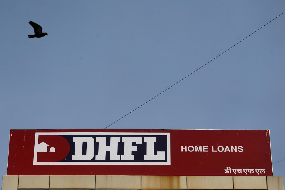 A bird flies past a signboard of Dewan Housing Finance Corporation Ltd. (DHFL) outside its office on the outskirts of Mumbai (Reuters file photo)