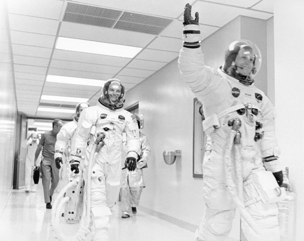 Mike Collins, Buzz Aldrin and Deke Slayton (dark shirt behind Aldrin to the left) follow Armstrong down the hallway. (Reuters File Photo)