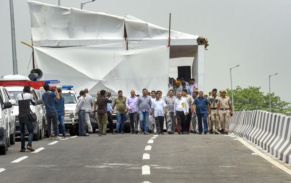 Delhi Chief Minister Arvind Kejriwal with his ministers and officials at the inauguration of the newly-constructed Rao Tula Ram Flyover, near Munirka in New Delhi. (PTI Photo)