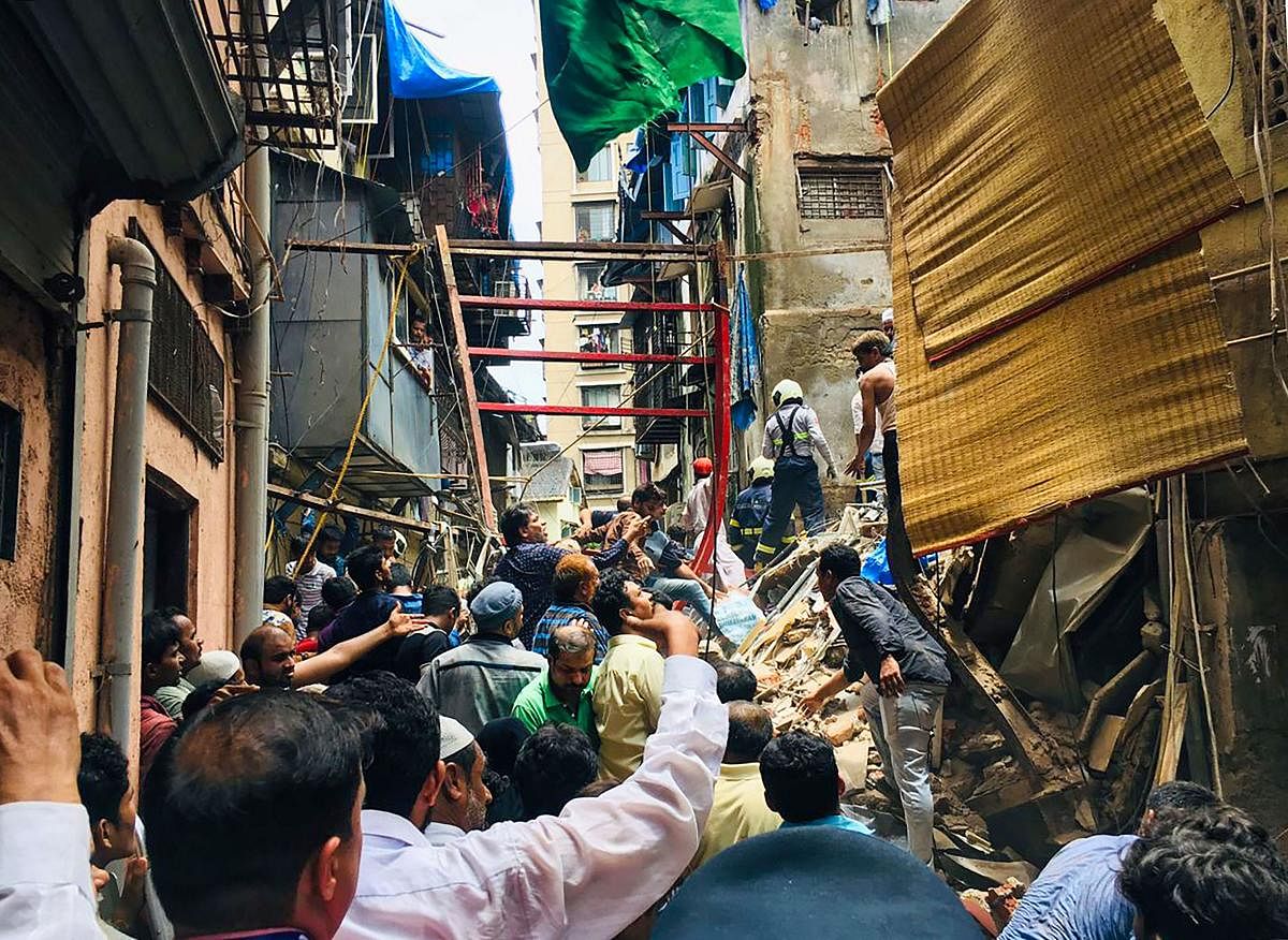 Rescue and relief work underway after the collapse of the four-storey Kesarbai building at Dongri in Mumbai. (PTI Photo)
