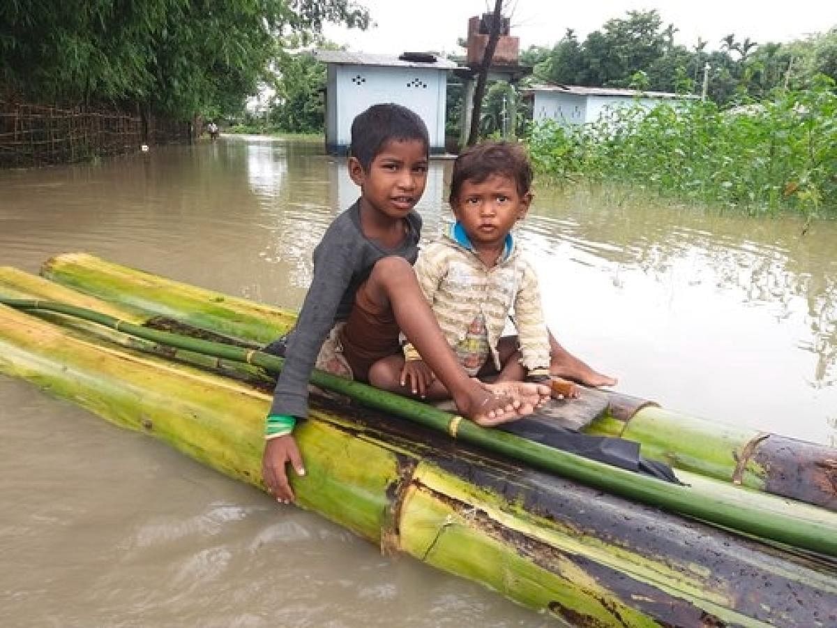 Two flood-hit children in a raft in Dhemaji district in Assam on Monday. Photo credit: Save the Children.