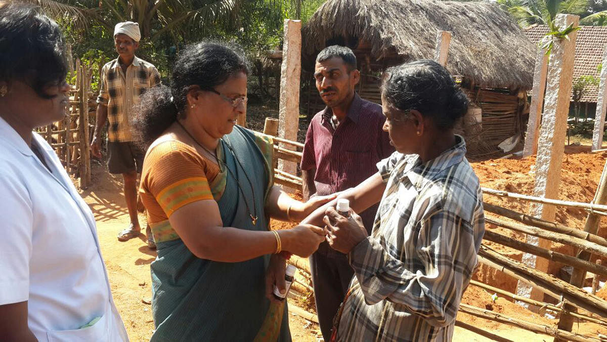 Health officials applying DMP oil to villagers in one of the villages of Thirthahalli taluk in Shivamogga district.