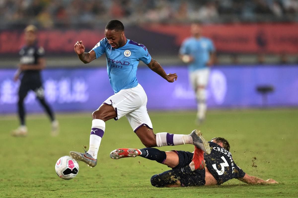 Manchester City's Raheem Sterling vies for the ball with West Ham United's Aaron Cresswell during their match at the 2019 Premier League Asia Trophy football tournament in Nanjing in China's Jiangsu province on July 17, 2019. (Photo by HECTOR RETAMAL / AF