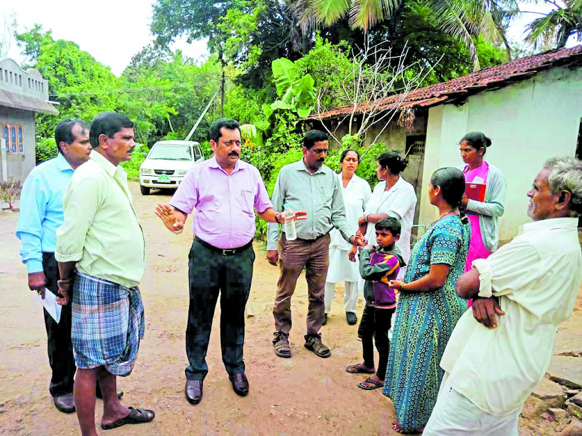 District Health Officer Dr K Mohan visited the houses in Thorenuru village on Wednesday, in the wake of the outbreak of viral fever in the village.
