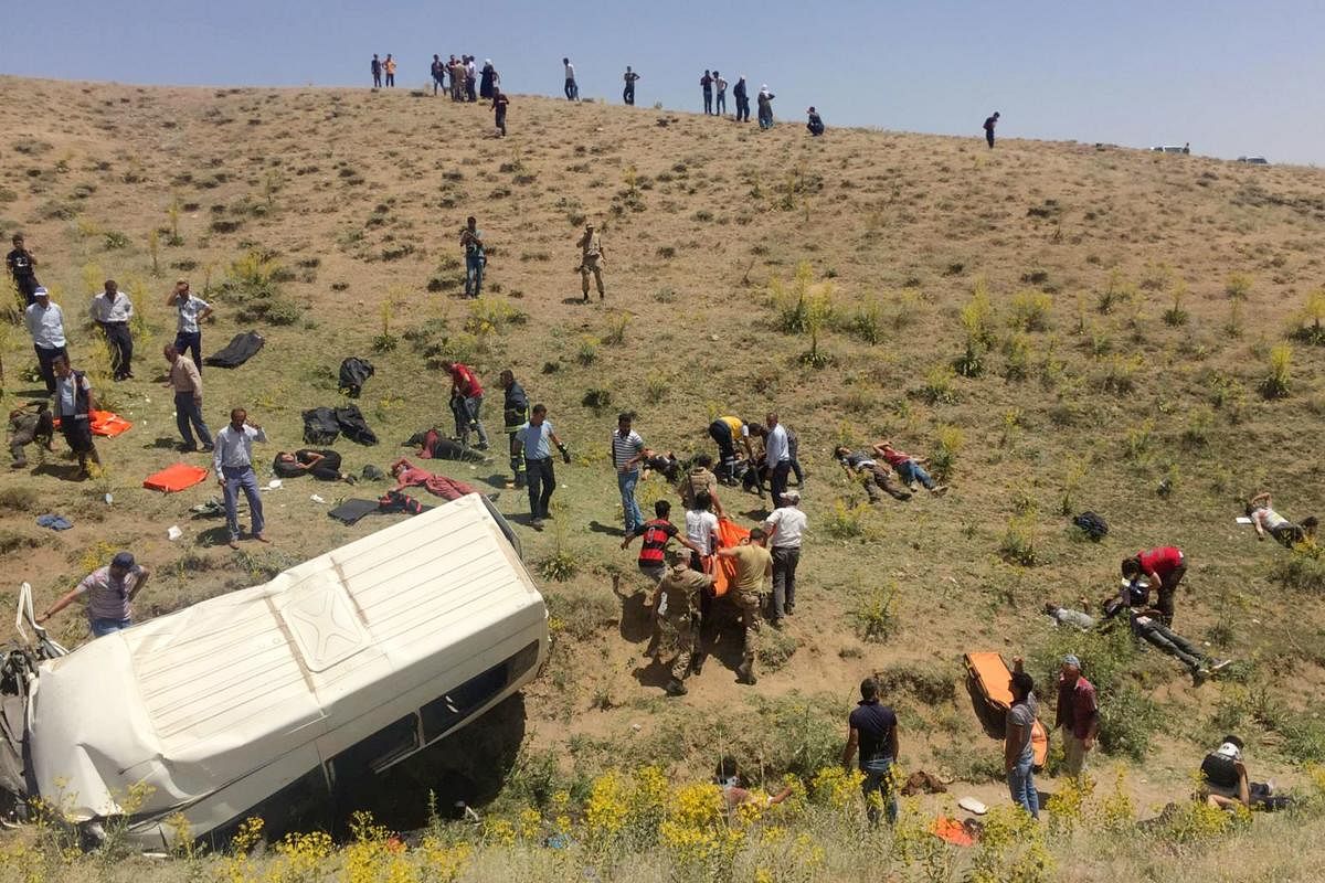 Rescue workers and Turkish soldiers carry injured migrants after a minibus accident in Van, eastern Turkey, on July 18, 2019. (AFP)