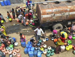 People collect water from a tanker at a drought-hit area of a village in Solapur,Maharashtra on Wednesday. PTI Photo
