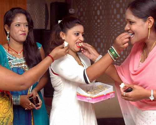 Bar girls celebrate with sweets the Supreme Court's ruling on dance bars in Mumbai on Tuesday. PTI File photo