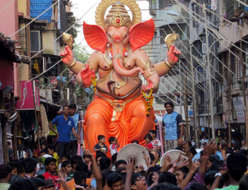 Devotees take a Ganesh idol to a pandal for the upcoming Ganesh Chaturthi festival in Thane, Mumbai on Saturday. PTI Photo