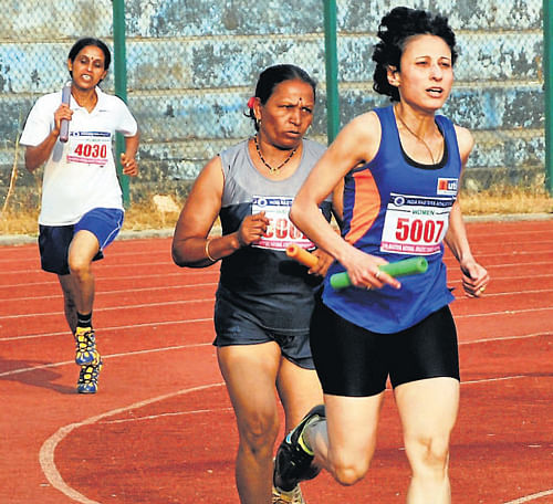Athletes competing in 4x100 metre relay for women on the final day of Masters National Athletic Championship at Mangala Stadium in Mangalore on Sunday. DH Photo