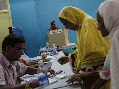 A woman casts her as vote others register inside a polling centre during the sixth phase of general election in Mumbai. The issue of deletion or diversion of six million voters' names in Maharashtra blew into a full-fledged controversy with demands ranging from repoll in all the state's 48 Lok Sabha constituencies to a CBI probe, following an apology tendered by Election Commissioner H.S.Brahma, who admitted to the lapse. Reuters photo