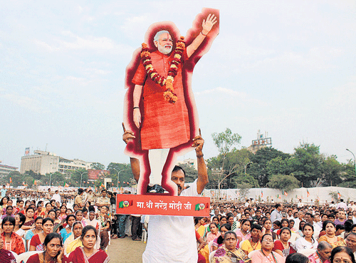 Larger than life: A supporter displays a cut-out of Prime Minister Narendra Modi at an election campaign rally at Kasturchand Park in Nagpur, Maharashtra on Tuesday.  pti