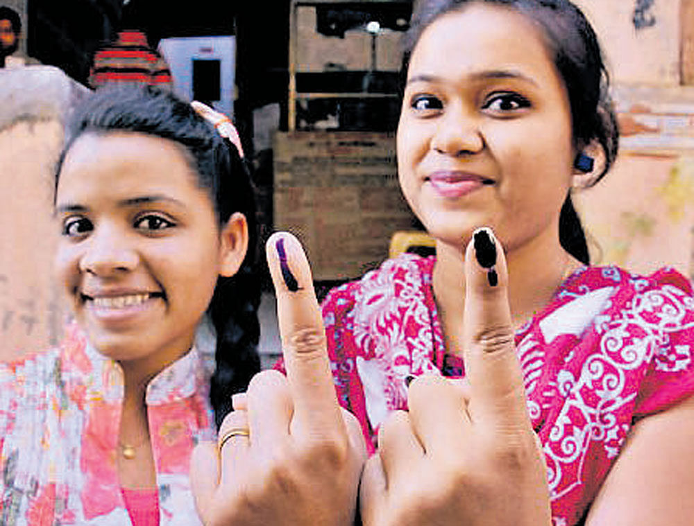 First time voters after exercising their franchise at a polling station in Nagpur on Tuesday. PTI