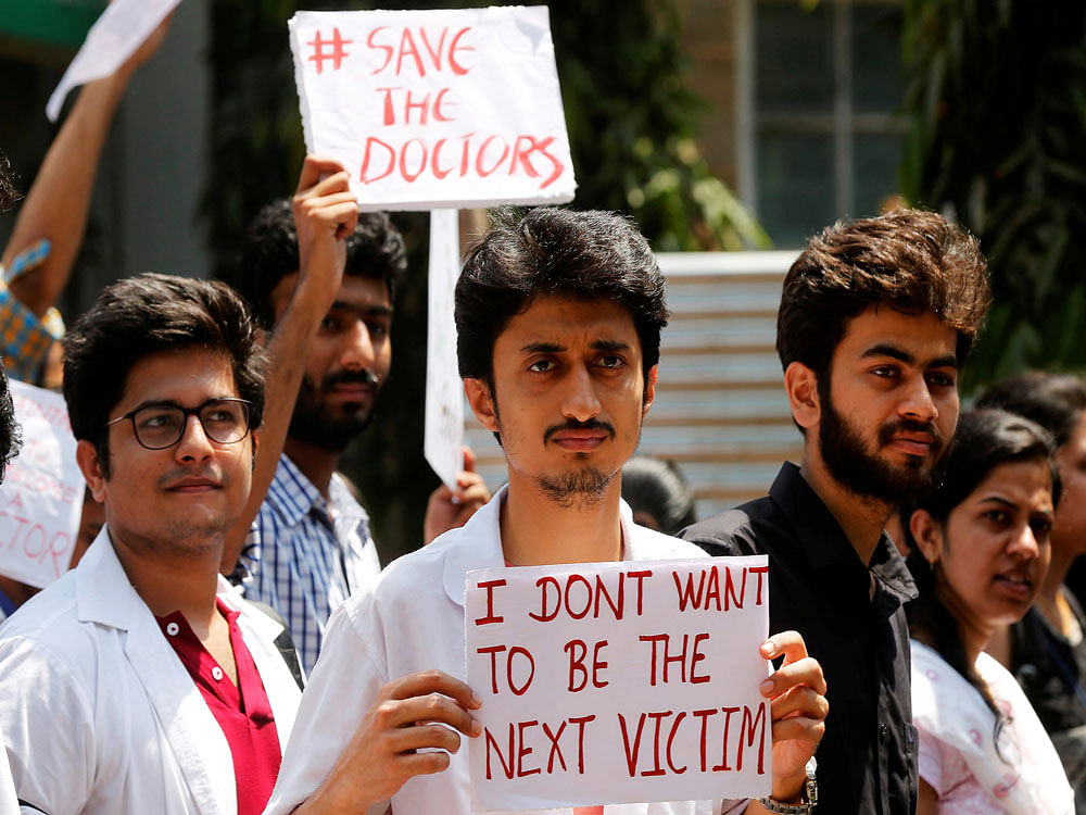 Doctors carry placards outside the King Edward Memorial (KEM) Hospital during a protest demanding security after the recent assaults on doctors by the patients' relatives, in Mumbai. Reuters photo