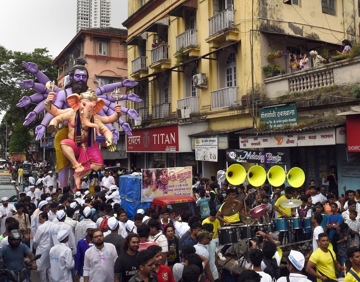 Devotees carry a Ganesha idol to be installed at a pandal ahead of Ganpati festival, in Mumbai on Sunday. PTI