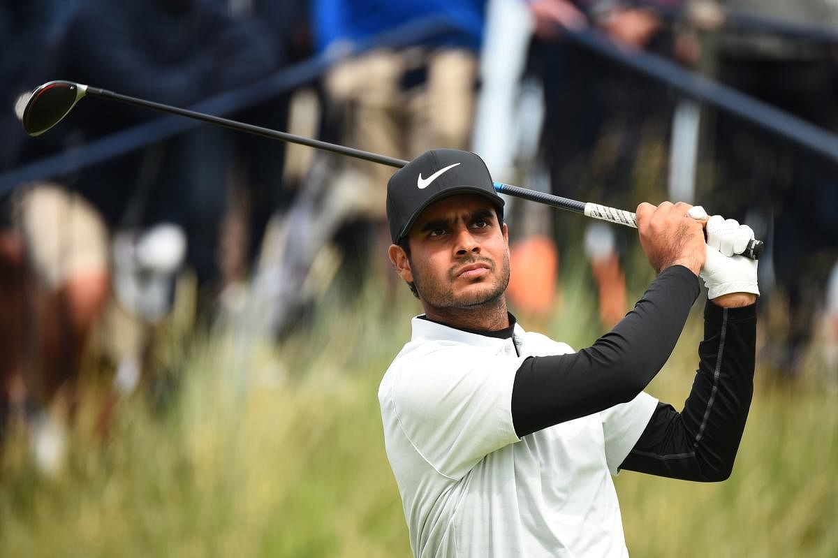 ndia's Shubhankar Sharma tees off from the 9th hole during the first round of the British Open golf Championships at Royal Portrush golf club in Northern Ireland (AFP Photo)