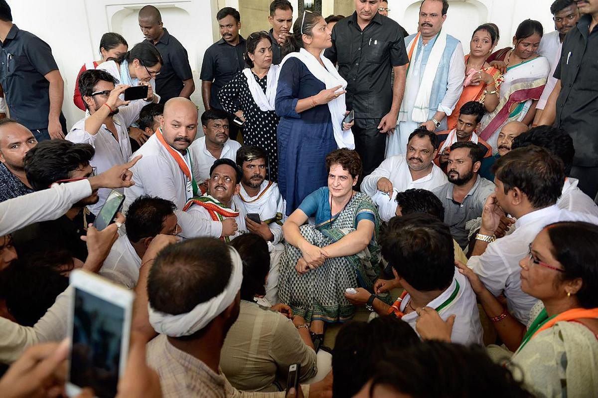 Congress General Secretary Priyanka Gandhi Vadra sits in protest, after she was stopped from proceeding to Sonbhadra to meet victims of clash that claimed 10 lives. (PTI  Photo)