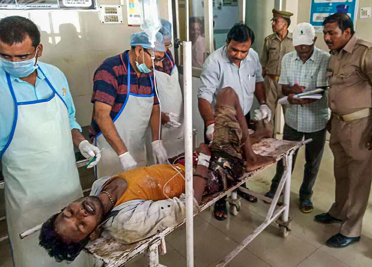 An injured being brought to a hospital in Varanasi, Wednesday, July 17, 2019. Nine people were killed and 20 others were injured in a property dispute in Sonbhadra district after a gunfight between two groups. Photo/PTI