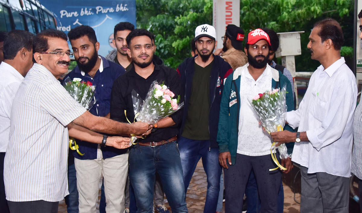 The job fraud victims, who returned from Kuwait, were welcomed in Mangaluru on Friday.