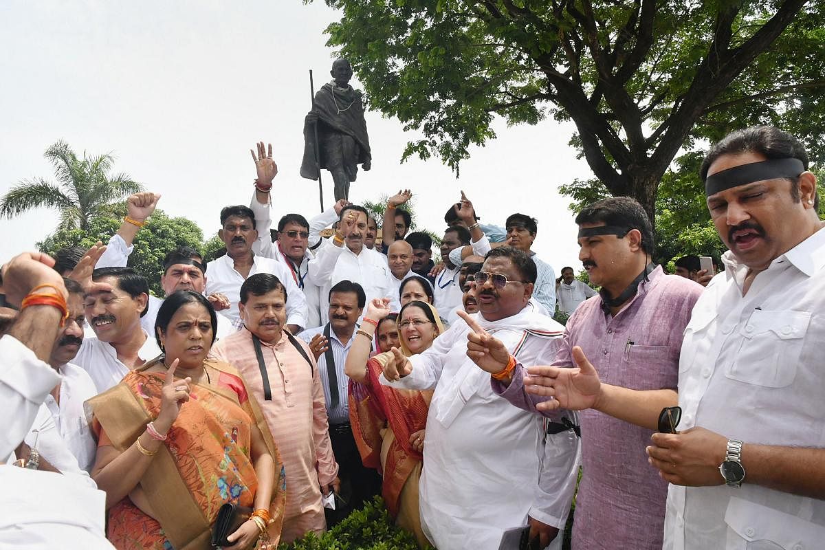 Madhya Pradesh ministers and Congress MLAs protest outside Madhya Pradesh Assembly after Priyanka Gandhi was stopped from proceeding to Sonbhadra to meet victims of clash that claimed 10 lives by Uttar Pradesh police, in Bhopal. PTI Photo