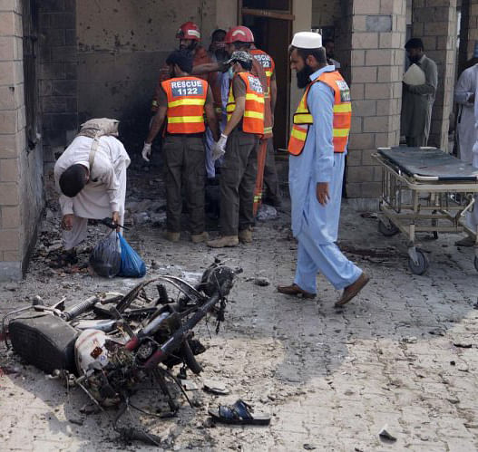 Dera Ismail Khan: Pakistani security officials and rescue workers gather at the site of a bombing on an entrance of a hospital in Dera Ismail Khan, Pakistan, Sunday, July 21, 2019. Police in Pakistan say gunmen opened fire on a police post and then bombed the entrance to a hospital as the wounded were being brought in.AP/PTI