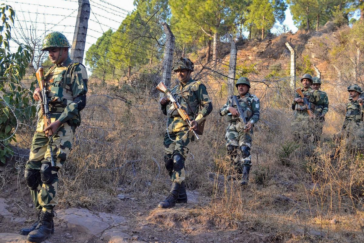 Poonch: Border Security Force (BSF) jawans patrol near Line of Control (LoC) in Poonch on Monday. PTI Photo (PTI2_19_2018_000200A)