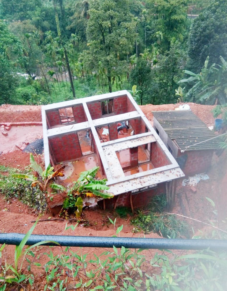 A hillock caved in on an under construction house at Jodupala, Kodagu, on Sunday.