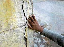 A resident points to the cracks in his house after an earthquake shook  Karachi on Wednesday. Reuters