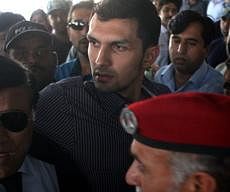 Pakistani wicketkeeper Zulqarnain Haider, center, is whisked away by security personals upon his arrival, as he ended his exile and returned home from Britain - AP photo