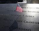 An American flag is stuck into the etched name of Father Mychal F. Judge, the New York Fire Department chaplain who died in the 9/11 attacks on the World Trade Center, at the National September 11 Memorial in New York . AP Photo