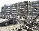 Security officials gather at the site of bomb blast in Peshawar on Saturday. AP