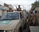 Security forces patrol at a suicide bomb blast site in Bannu December 10, 2012. Four Taliban suicide bombers attacked a police station in northwest Pakistan on Monday, killing at least eight policemen and local residents, security officials said. REUTERS