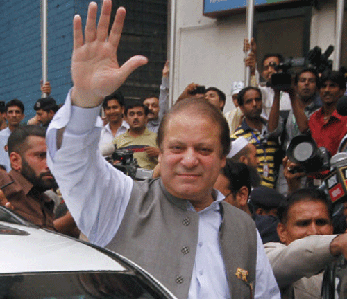 Original Nawaz Sharif, leader of the Pakistan Muslim League - Nawaz (PML-N) political party, waves as he arrives to cast his vote for the general election at a polling station in Lahore Reuters Image