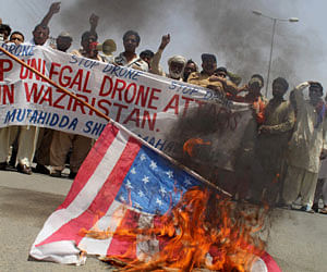 Pakistani protesters burn a representation of a U.S. flag to condemn a drone attack in the Pakistani tribal area of Waziristan which killed Taliban leader Waliur Rehman, Thursday, May 30, 2013 in Multan, Pakistan. The Pakistani Taliban's deputy leader was buried hours after he was killed in a U.S. drone strike, Pakistani intelligence officials and militants said Thursday. AP Photo