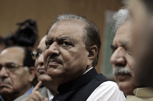 Mamnoon Hussain, presidential candidate of the Pakistan Muslim League-Nawaz party, stands as he submits his nomination papers for the upcoming presidential election in Islamabad. Reuters