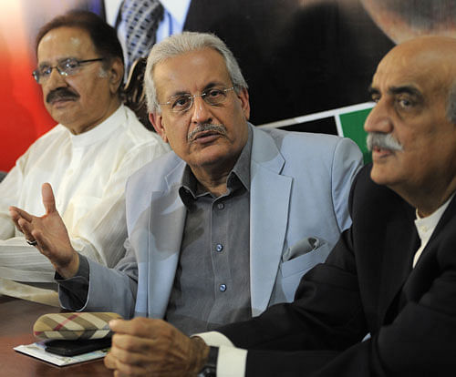 Pakistani presidential candidate Raza Rabbani, center, from Pakistan's opposition Pakistan People Party, addresses a news conference with opposition leaders Amin Fahim, left, and Khursheed Shah in Islamabad, Pakistan on Friday, July 26, 2013. Pakistan's former ruling party, the Pakistan People's Party, will boycott the upcoming presidential election, saying Friday that the decision to move the vote forward by a week deprived it of enough time to campaign. AP Photo