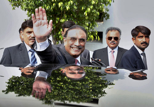 Pakistan's outgoing President Asif Ali Zardari waves as he leaves following a farewell ceremony at President House in Islamabad, Pakistan. Zardari is stepping down Sunday at the end of his five year term, becoming the first democratically elected president in the country's history to complete his full tenure in office. (AP Photo)