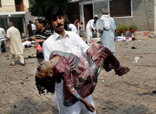 A Pakistani man carries the lifeless body of a girl from the site of a suicide attack at a church in Peshawar, Pakistan, Sunday, Sept. 22, 2013. A suicide bomb attack on a historic church in northwestern Pakistan killed scores of people on Sunday, officials said, in one of the worst assaults on the country's Christian minority in years. AP Photo