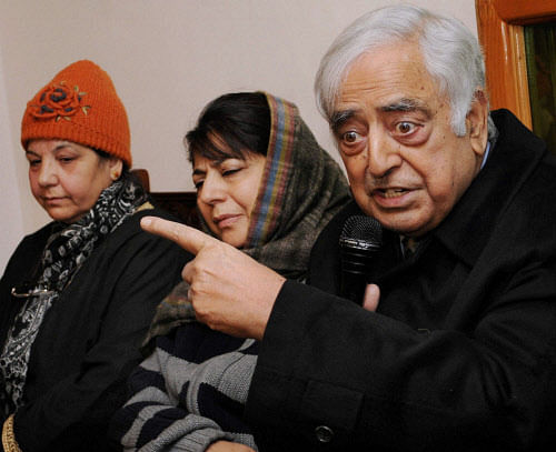 Jammu and Kashmir Peoples Democratic Party (PDP) party patron Mufti Mohd Sayeed along with his daughter and party president Mehbooba Mufti addressing a press conference at his residence in Srinagar on Friday. PTI Photo