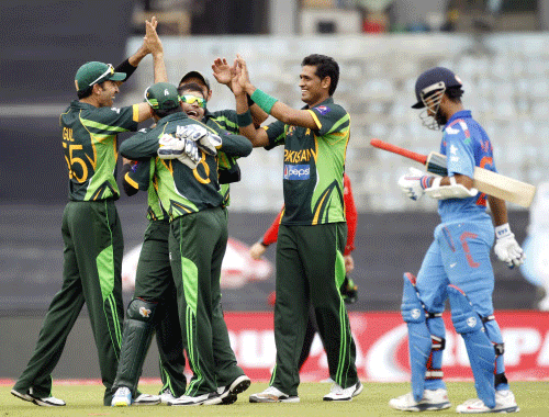 India's Ajinkya Rahane (R) leaves the field as Pakistan's fielders celebrate his dismissal during their one-day international (ODI) cricket match in Asia Cup 2014 in Dhaka March 2, 2014. REUTERS