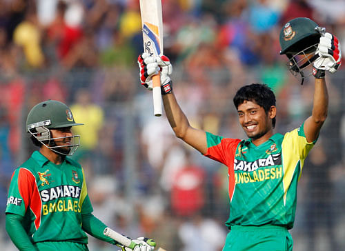 Bangladesh's Anamul Haque celebrates after scoring a century as Mominul Haque (L) watches during their one-day international (ODI) cricket match against Pakistan of the Asia Cup 2014 in Dhaka March 4, 2014. REUTERS